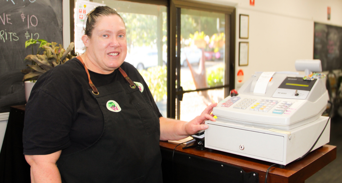 windara employee standing at the till in uniform