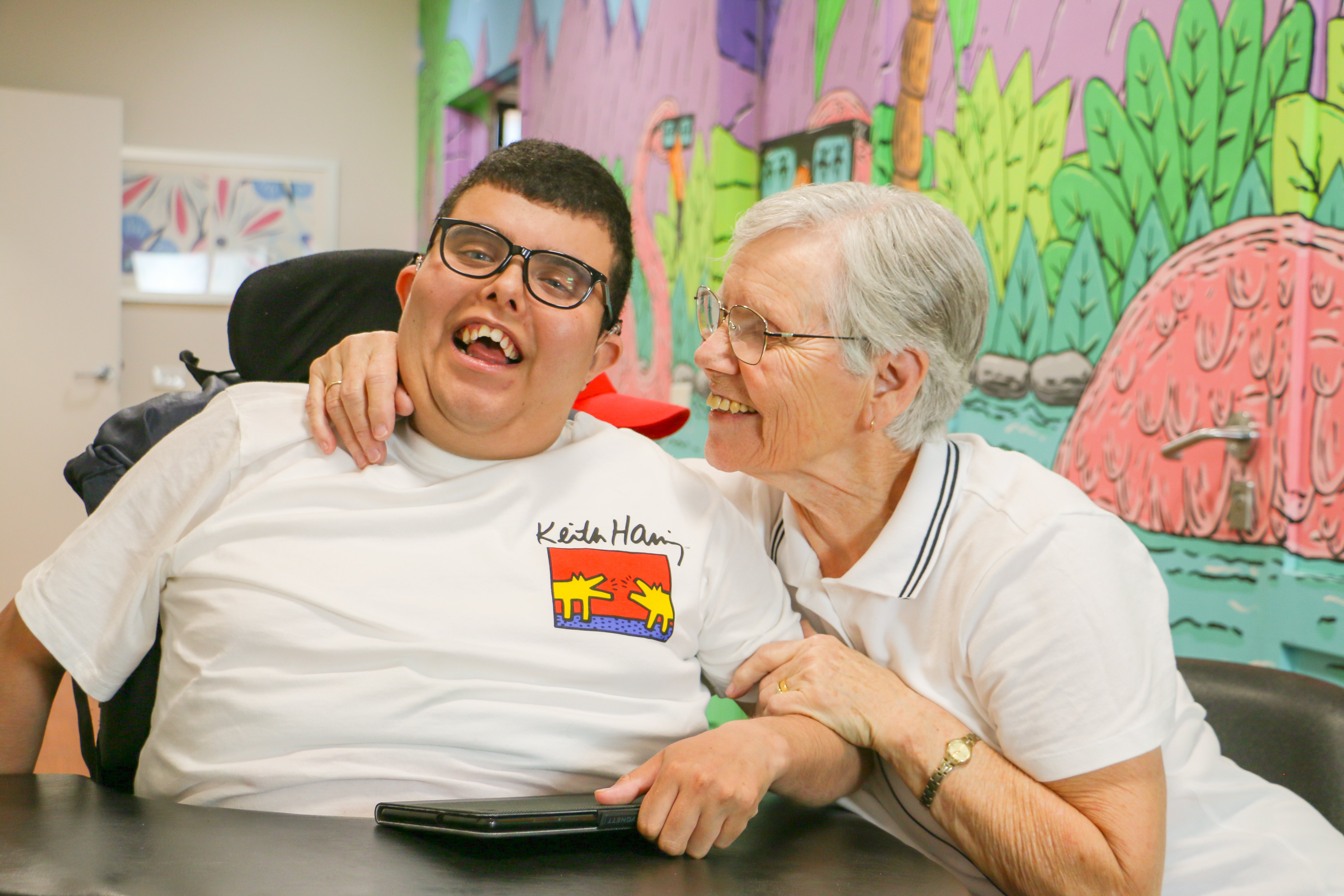 A mother and son at summer hill house smiling together