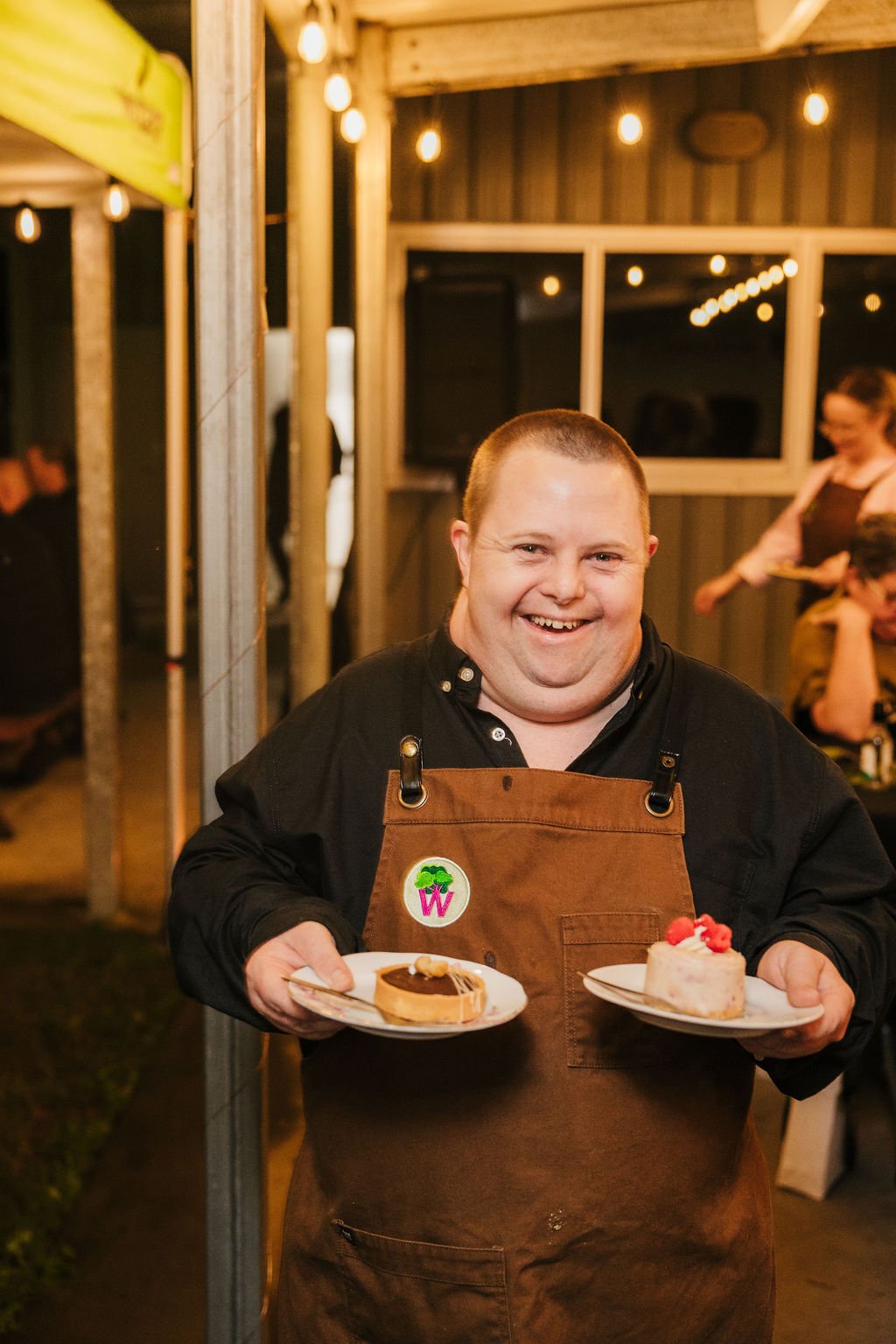 Man with disability working as a waiter wearing an apron