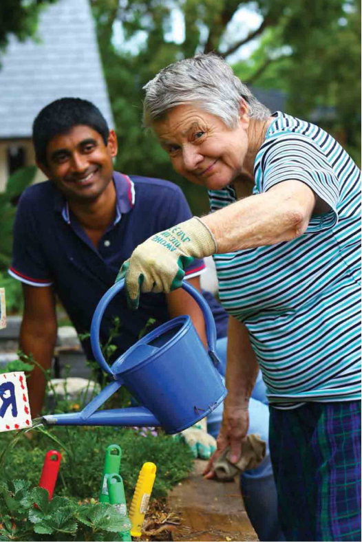 a woman with disability watering her plants